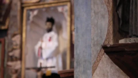 Monument to catholic priest inside mission Stock Footage