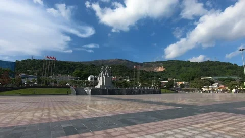 A monument of coal miners in Cam Pha, Vietnam with a coal mine at the background Stock-Footage 217899315