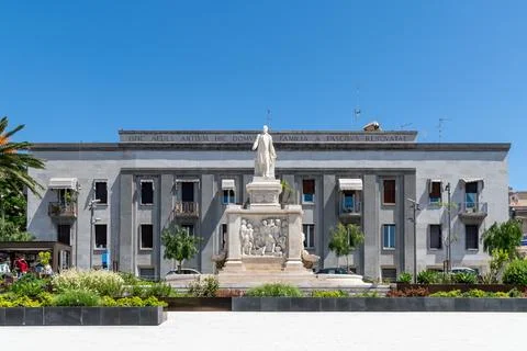 Monument in front of grey facade building Stock Photos