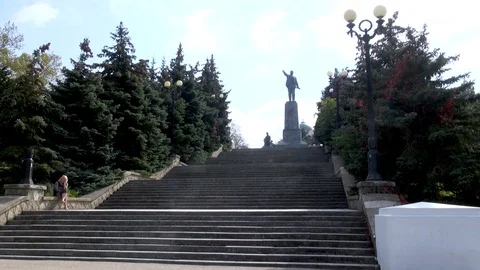 Monument to Lenin on high hill. Along stairs grow evergreen spruce. Stock Footage 106111404