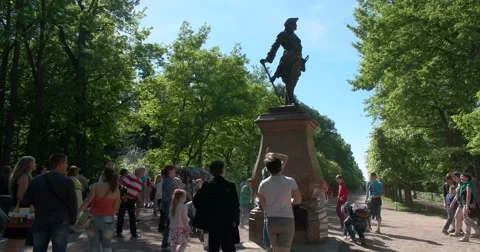 The Monument To Peter The Great. Tourists throw coins into the hat.. Petergof Stock Footage 62877388