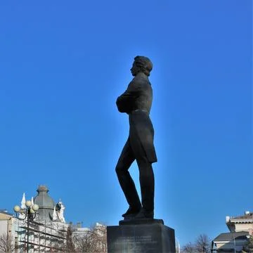 Monument to Pushkin on the square under the blue sky Stock Photos
