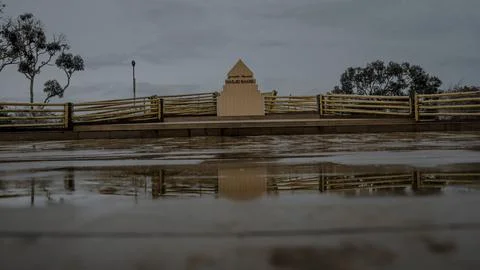 Monument Reflection on Wet Pavement Stock Photos