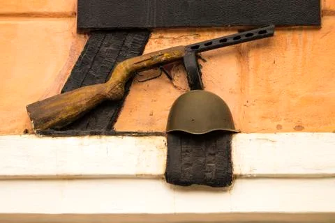 Monument to the second world war, a helmet and a gun Stock Photos