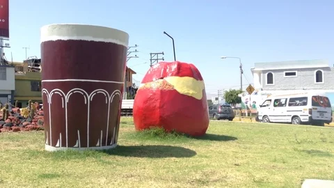 Monument Stuffed hot pepper and Chicha abode with cars Stock Footage 82465574