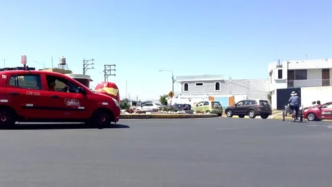 Monument Stuffed hot pepper and Chicha abode with cars Timelapse Stock Footage 82471713