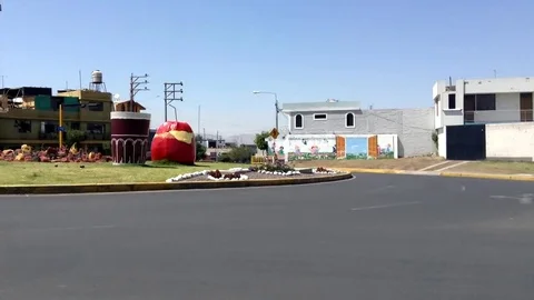Monument Stuffed hot pepper and Chicha abode with cars Timelapse Down to Up Stock Footage 82471740