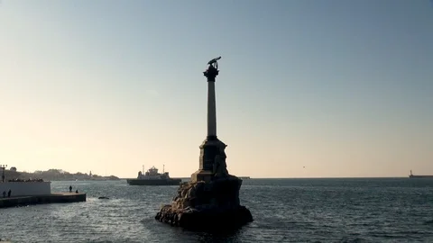 Monument to sunken ships on background of passing ferry. Stock Footage 106062497