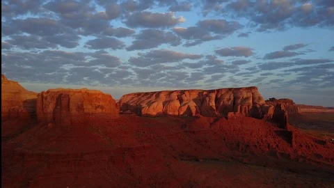 Monument Valley drone flying forward over rocks at sunrise Stock Footage 89021788