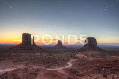 Monument valley holiday destination backlit by sunrise Stock Photos