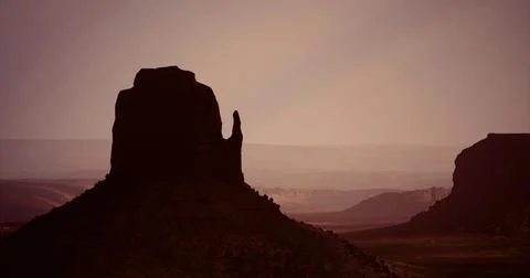 Monument Valley rock formations at sunset creating breathtaking silhouettes Stock Illustration