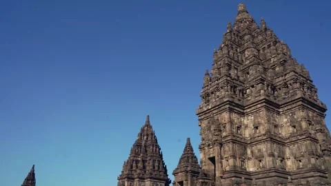 Monumental Prambanan Temple tower rises above smaller spires beneath a vivi.. Stock Footage 341544095