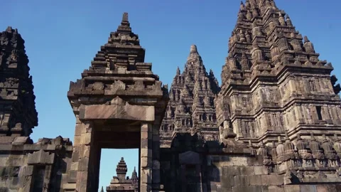Monumental stone gateway frames the majestic towers and spires of Prambanan.. Stock Footage 341542456