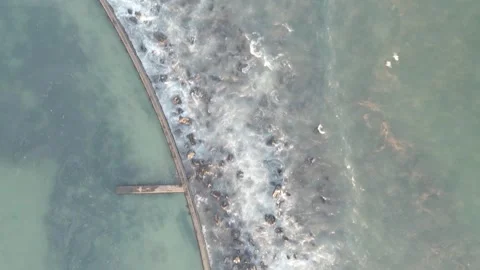 Monwabisi Beach waves crashing on breakers with birds drone aerial shot Stock Footage 277386833