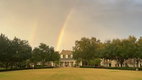 Moody atmosphere with rainbow over a beautiful house in nature after rain. Stock Footage 337264174