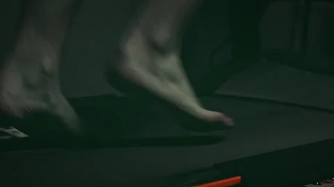 Moody Close-up of Barefoot Running on a Treadmill with Audio Video stock 329764259