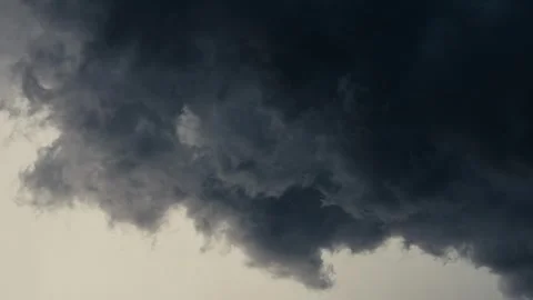 Moody clouds move in formation as a storm cell passes above the town of Sleepy Stock Footage 314637575
