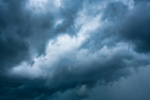 Moody dramatic blue sky and stormy cloud during thunderstorm Stock Photos