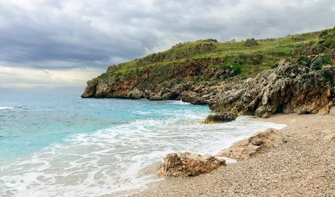 Moody dramatic cliff shore line tranquil sea scape scenery view and backgroun Stock Photos