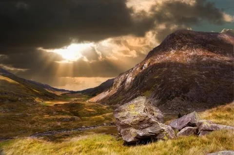 Moody dramatic mountain sunset landscape Stock Photos