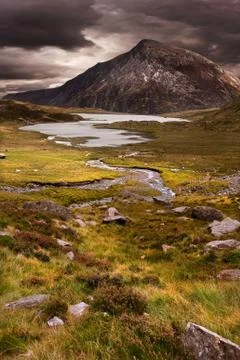 Moody dramatic mountain sunset landscape Stock Photos