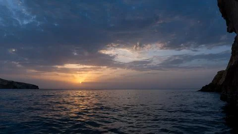 Moody dramatic sunset in sea Stock Photos