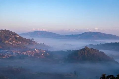 Moody Dramatic view of hills covered in fog and Great Himalaya Range in the b Stock Photos