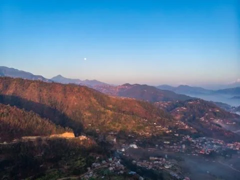 Moody Dramatic view of mountains covered in fog during sunrise with Great Him Stock Photos