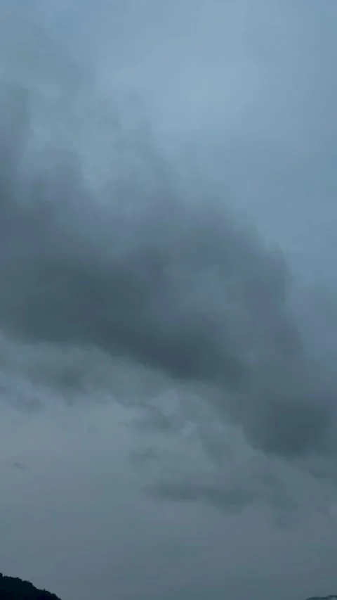 Moody evening sky with dark clouds forming an ominous pattern against a dee.. Video stock 338414622