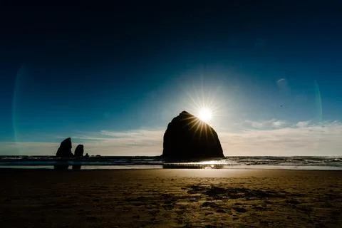 Moody image of haystack rock just before sunset Stock Photos
