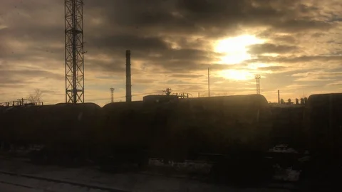 Moody industrial sunset view from train window Stock Footage 124730877