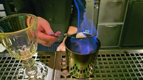 Moody mixology scene with bartender working over blue flames, using a Stock Footage 339848789