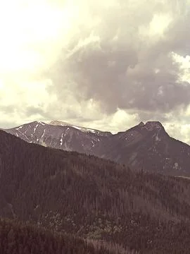 Moody mountain range under cloudy sky Stock Photos