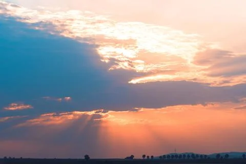 Moody orange sunset between the clouds sky Stock Photos