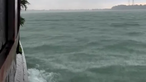 Moody Rain and Stormy Waves on River from Moving Boat Stock Footage 337715838