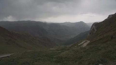 Moody storm clouds over a mountain valley, Kyrgyzstan Stock Footage 347243018