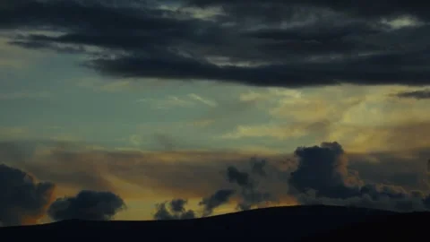 Moody timelapse of dark clouds in the evening sky smoothly transitioning from Stock Footage 313731148