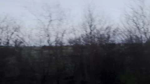 Moody tracking shot from a train window of frost-covered Hungarian fields at Vídeos de archivo 334632013