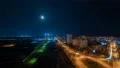 The moon above the night city. time lapse 4k or 4k+ Resolution