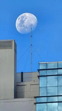 Moon Aligned with Antenna at Sunset Stock Photos