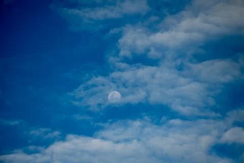Moon Among Layered Clouds in Blue Krabi Sky Фото