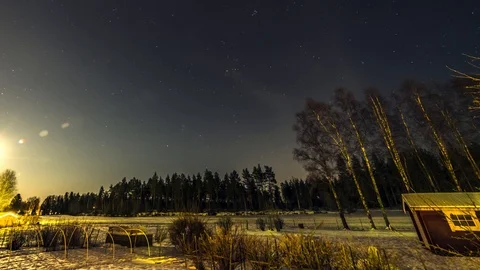 Moon and clouds fly over winter scandinavian forest timelapse 5 hours with ha Stock Footage 89976558