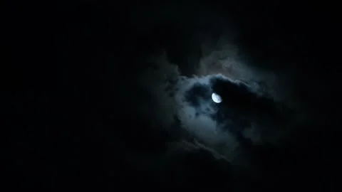 Moon and clouds in the night black sky. Clouds floating in wind blowing against Stock Footage 311939253