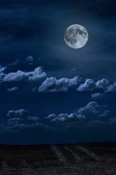 Moon and clouds in the night. Moonlight and road background. Stock Photos