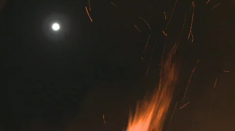 Moon and flames from a fire Stock Footage 853675
