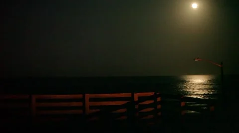 Moon and Moonlit Ocean Waves Near Dock Stock Footage 46414949