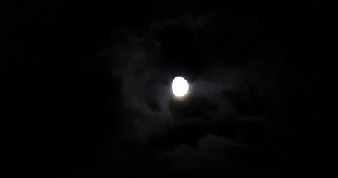 Moon and night sky with clouds passing medium shot Stock Footage 208309995