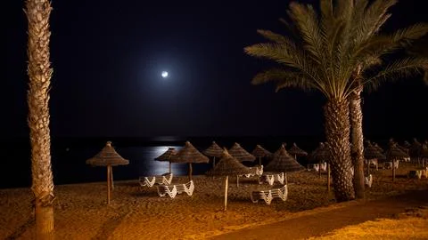 The moon and reflection in the ocean at Playa del Camisón, Tenerife Stock Photos