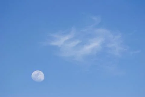 Moon and soft clouds in evening sky Stock-Fotos