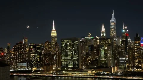 Moon and Venus setting behind the NYC Skyline Stock Footage 327925563